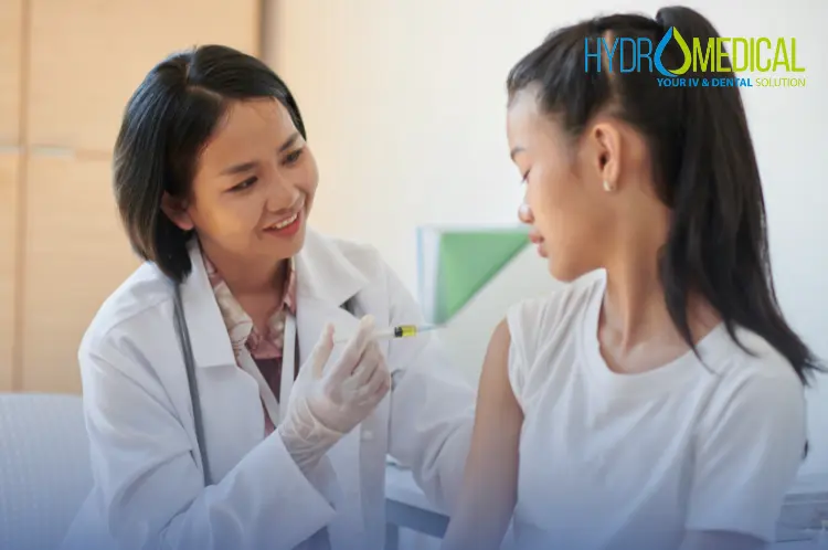 Licensed nurse administering a travel vaccination to a patient's arm during a home visit service in Bali.