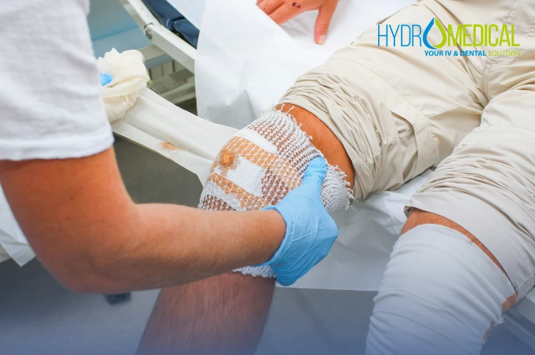 Nurse providing professional wound care for "scooter rash" (minor injury) at Hydro Medical Clinic Bali.