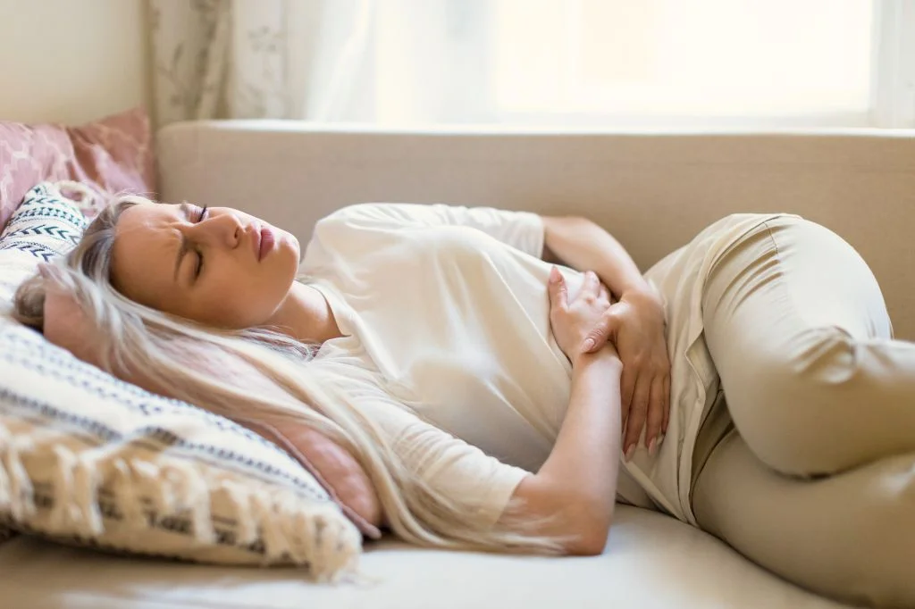 Person experiencing lower abdominal pain and discomfort, unsure if it is a UTI or STD.