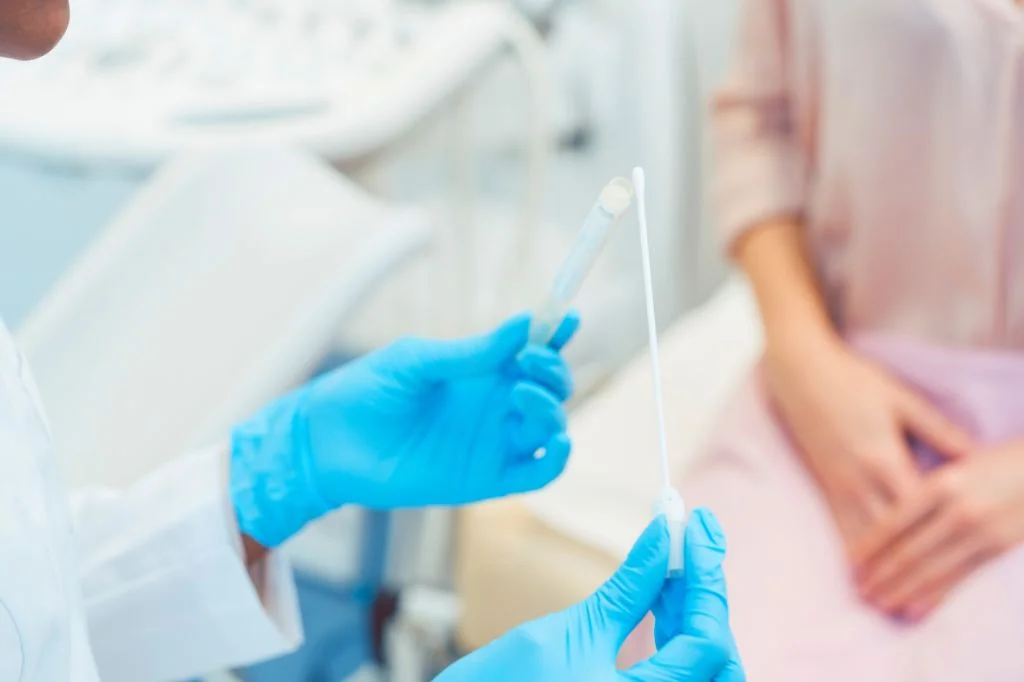 A doctor performing a high-tech vaginal swab test at a Bali clinic to diagnose discharge.