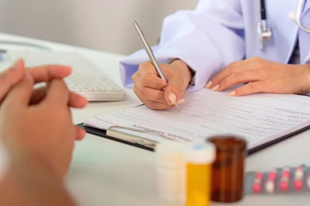 A doctor at Hydro Medical Clinic providing a confidential, non-judgmental STD consultation.