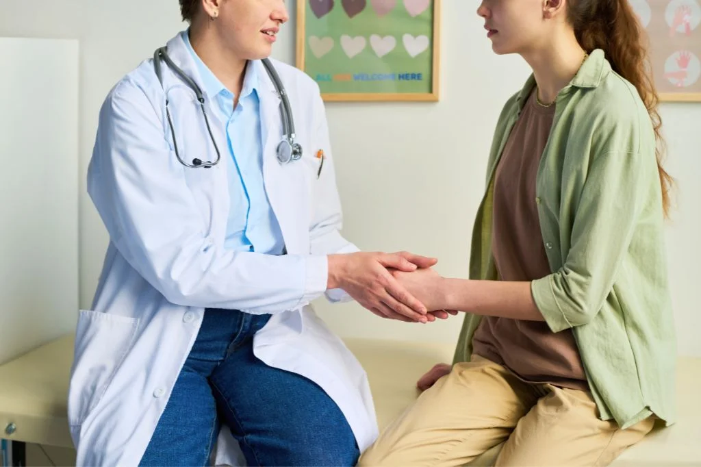 A doctor at Hydro Medical Clinic discussing a confidential post-holiday health check with a patient.