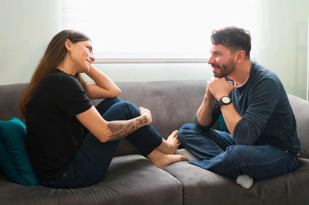 A couple supporting each other while discussing a serious health matter like an STD.