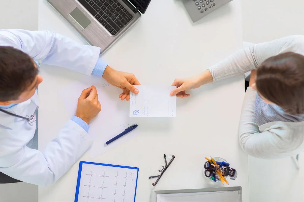 A patient consulting with a doctor about HPV treatment options in a private clinic.