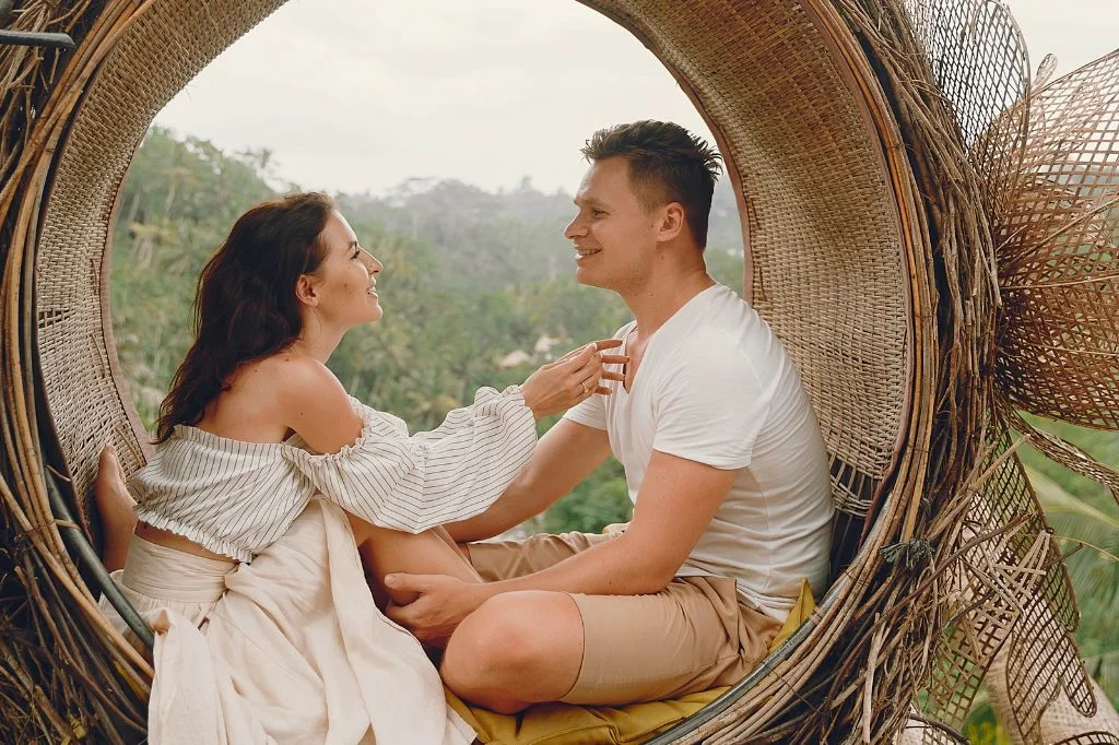 A healthy, confident couple enjoying an active lifestyle in Bali, representing successful HIV management.