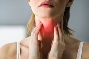 Person suffering from a sore throat in Bali after a night out.
