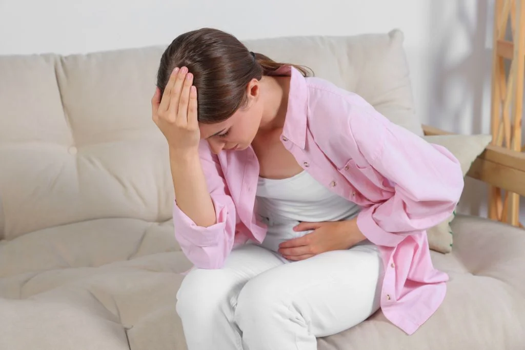 A woman feeling frustrated that her UTI symptoms (burning) are not going away, possibly indicating Chlamydia.