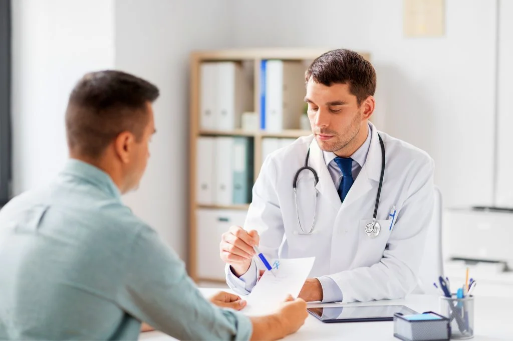 Patient consulting with a doctor about rabies vaccination timing at a medical clinic.