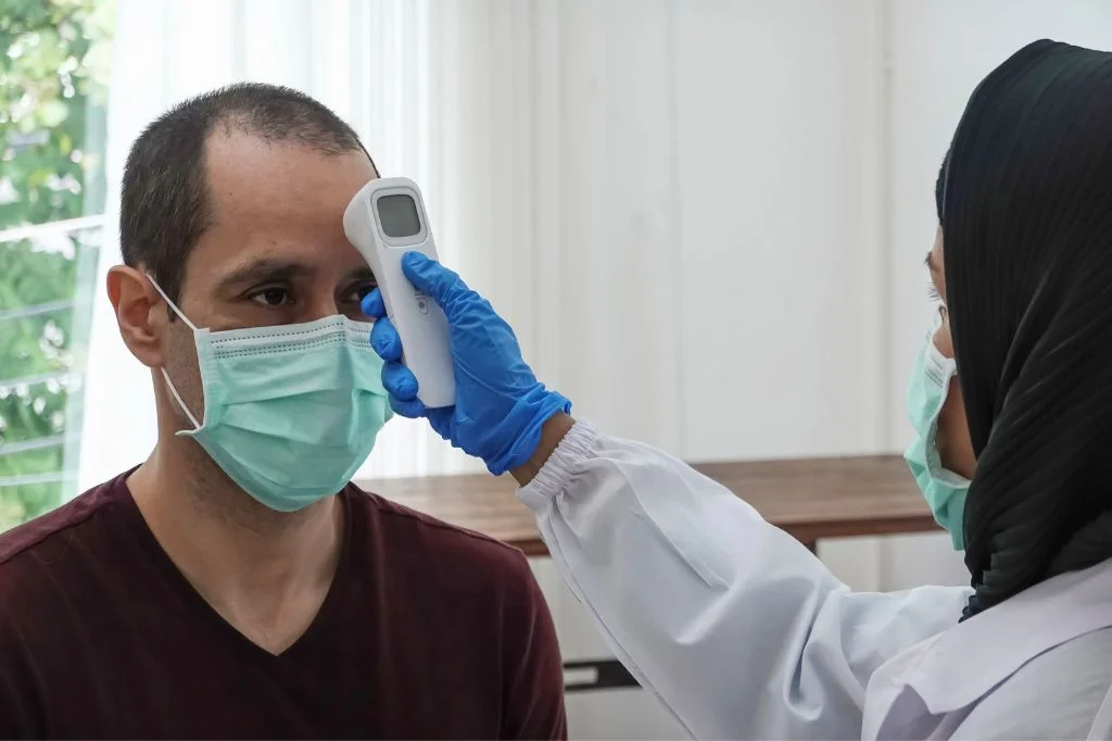 Doctor checking patient vital signs and reflexes at Hydro Medical Clinic Bali.
