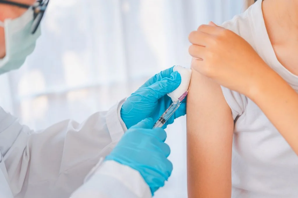 Patient checking arm soreness after rabies vaccination injection.