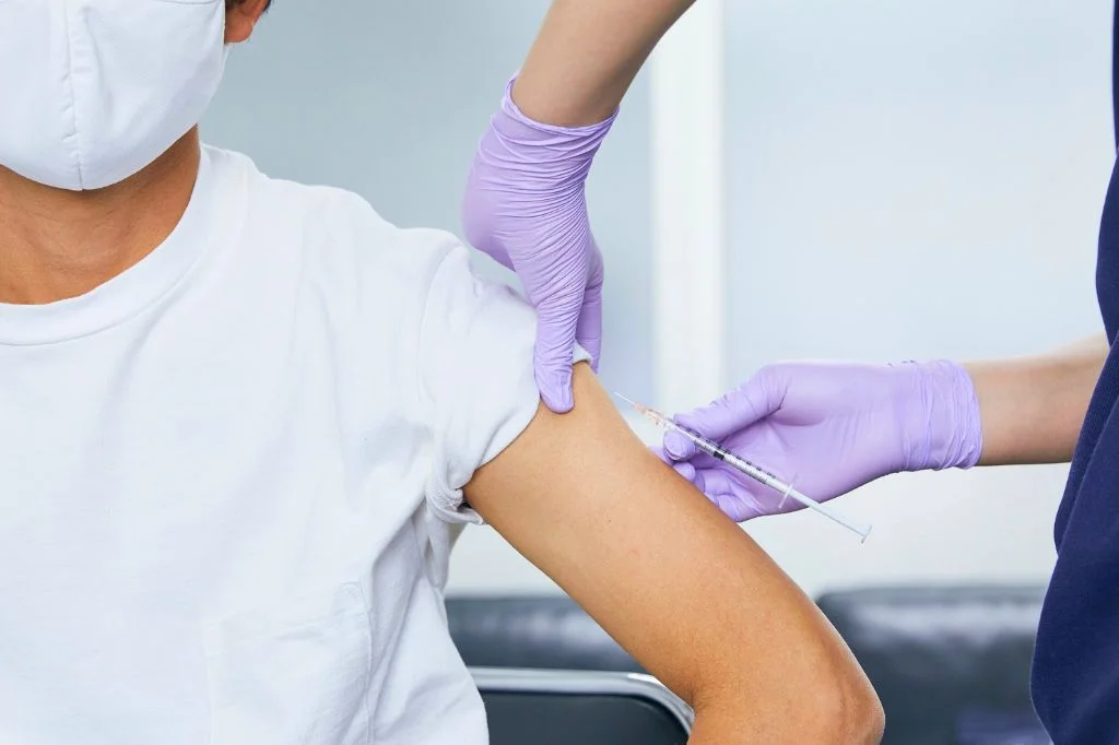 Professional doctor preparing rabies vaccine injection in a Seminyak medical clinic.