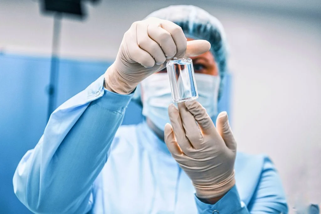Professional medical team holding a sterile vaccine vial