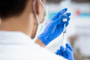 Doctor holding a Verorab rabies vaccine vial at Hydro Medical Bali to show authenticity.