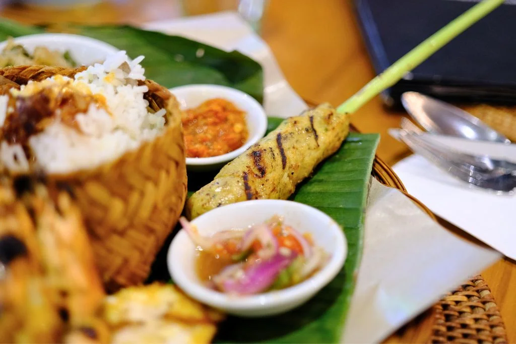Spicy Balinese sambal and oily food, common dietary triggers that cause acid reflux and sore throat in tourists.