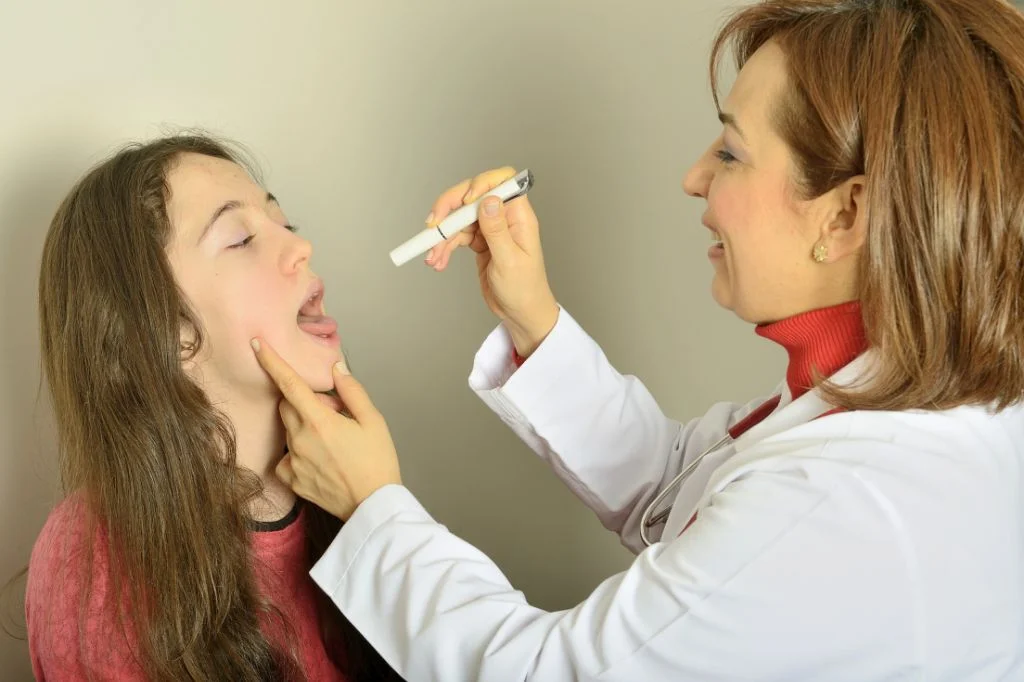Hydro Medical ENT specialist examining a patient's throat to identify and remove tonsil stones.