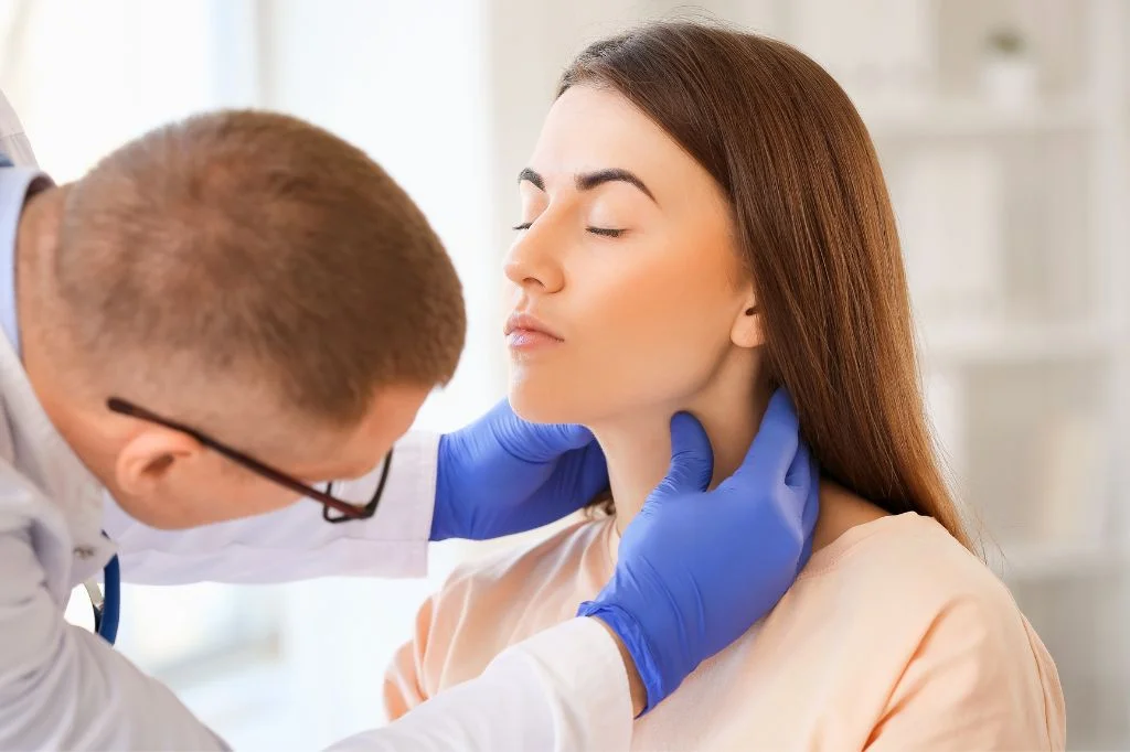 Hydro Medical doctor examining a patient's throat to diagnose the cause of hoarseness.