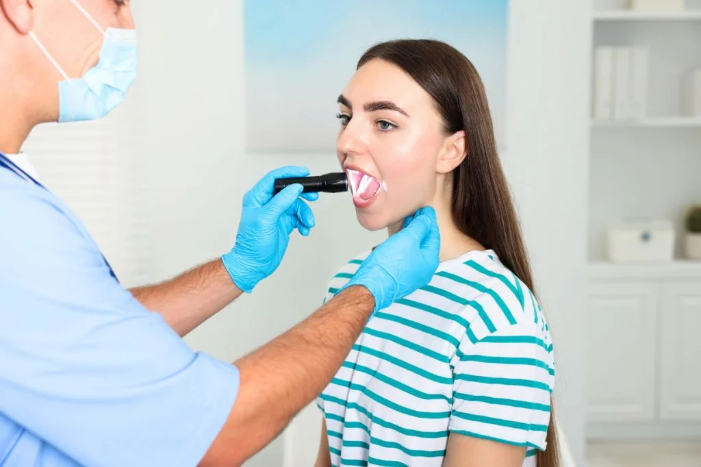 Hydro Medical doctor performing a throat examination to diagnose ENT issues.