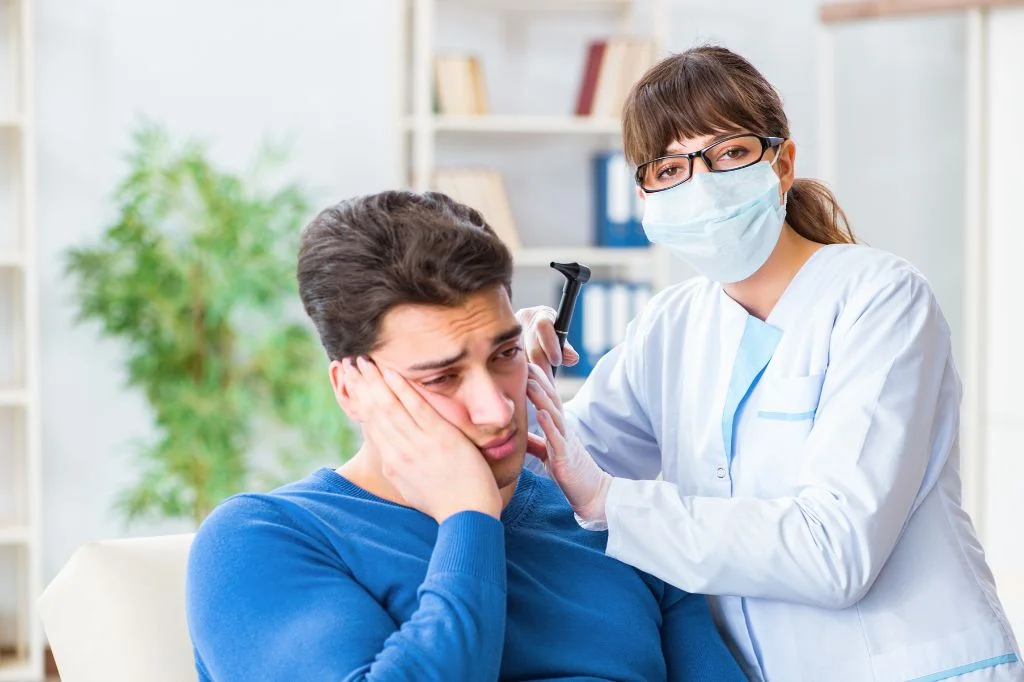 Hydro Medical doctor checking for eardrum damage or acoustic trauma.
