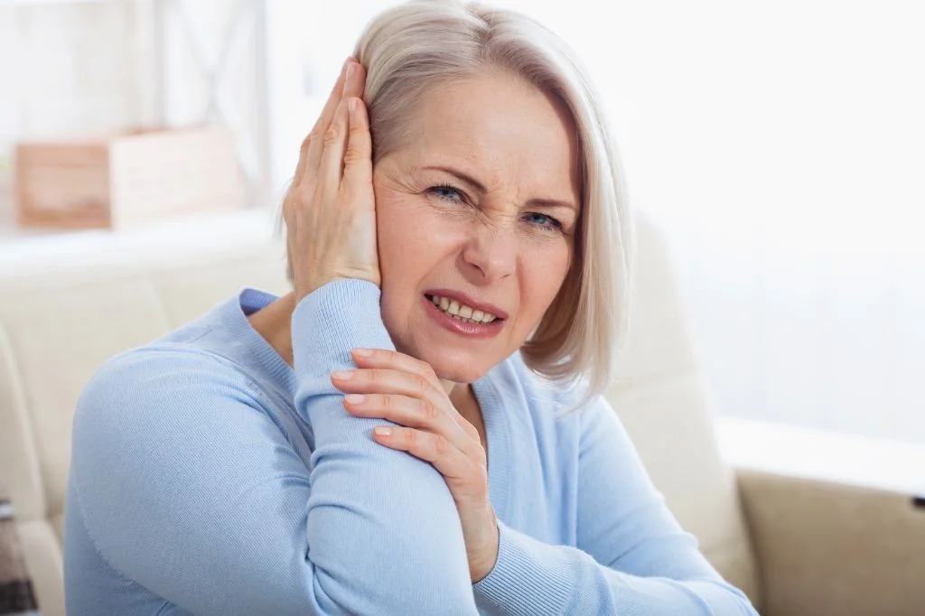 A tourist in Bali experiencing ear pain and sore throat symptoms.