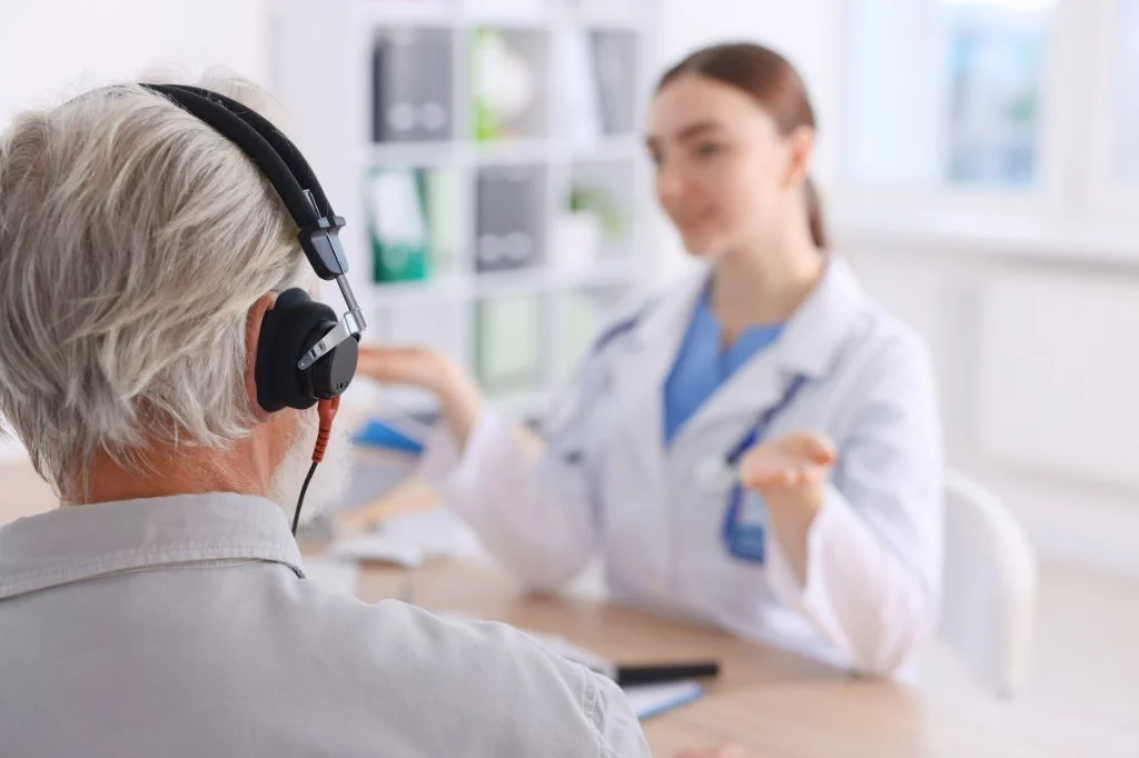 A patient undergoing a professional Audiometry hearing test at Hydro Medical Bali using specialized headphones.