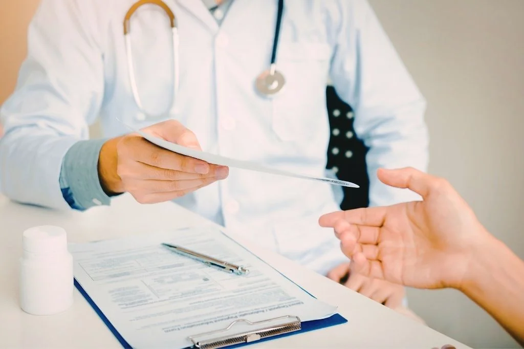 An ENT specialist discussing a hospital referral plan with a patient for complex surgery.