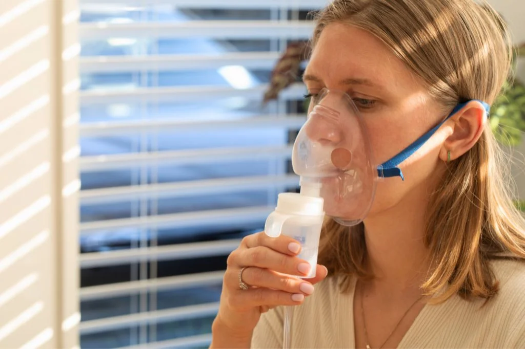 Using a medical nebulizer to deliver medication directly to the throat and lungs for fast relief.