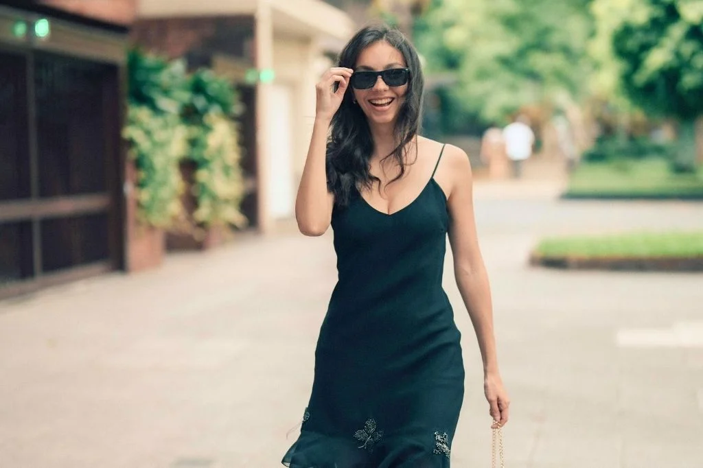 A confident woman wearing a dress/fit-body clothes enjoying an outdoor activity, showcasing the body shape results after a CM Slim treatment in Bali.