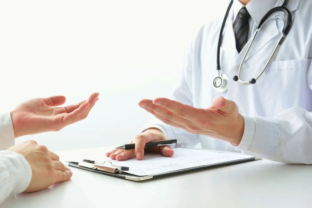Internal medicine specialist consulting with an expat patient at a professional clinic in Bali.