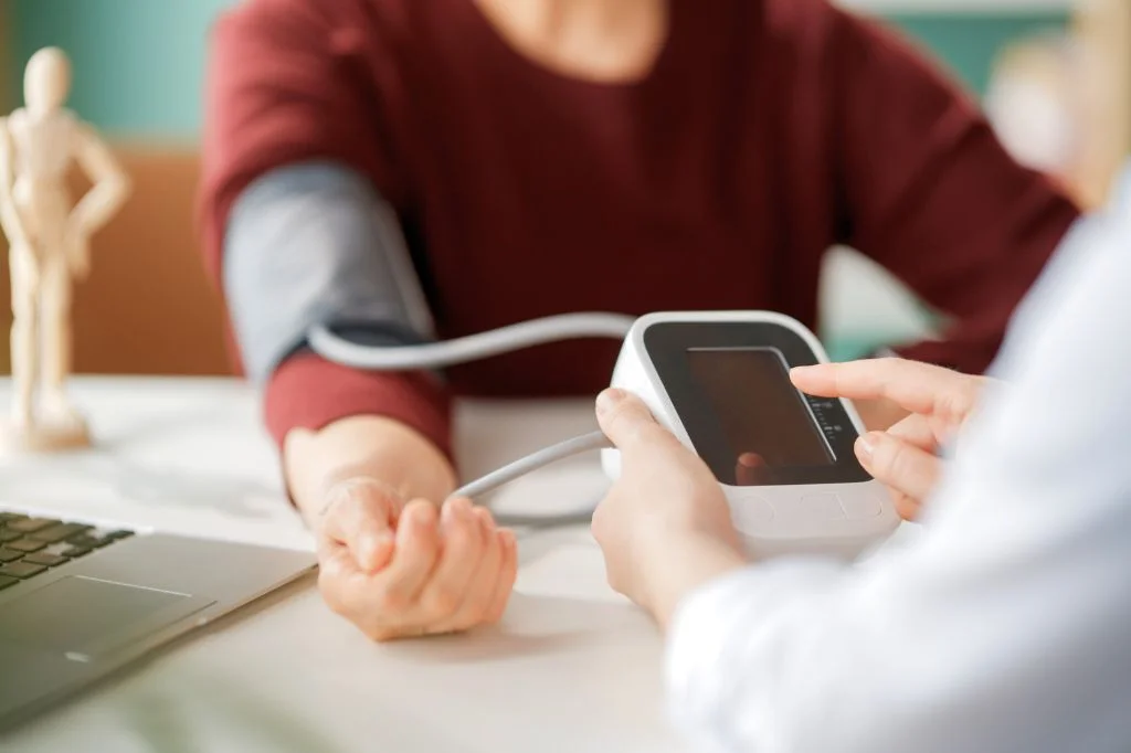 An internist performing a professional and warm health examination on a patient.