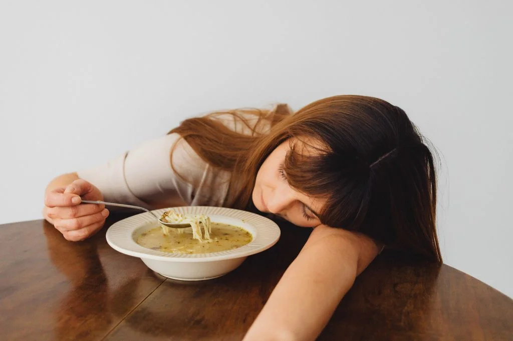 An individual experiencing fatigue after a meal, a potential sign of metabolic stress.