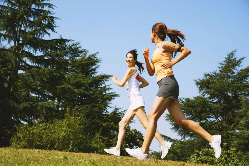 A couple of girls running outdoor in Bali tropical settings after getting the infection treatment