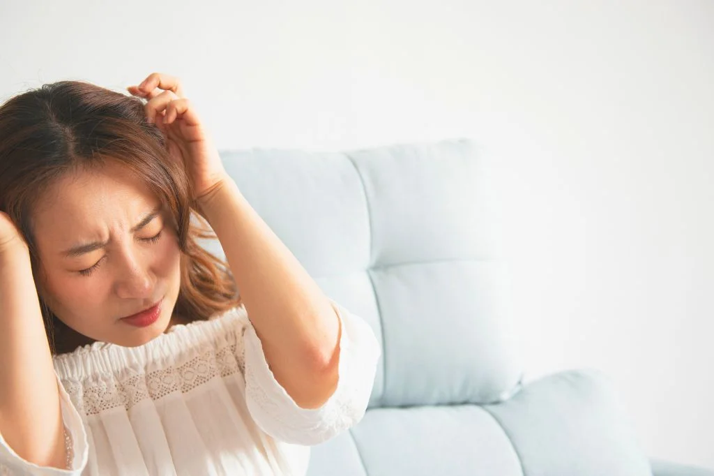 A traveler experiencing a severe migraine after sun exposure in Bali.