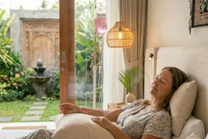 A tourist receiving professional IV therapy in a modern Bali villa for hydration and wellness in 2026.