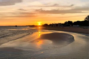 The iconic Kuta Beach coastline and vibrant tourist hub in Bali.