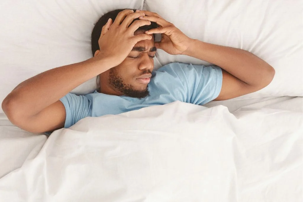 A tourist experiencing a severe hangover at a Bali villa before choosing an IV drip package.