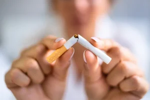 A traveler smoking outdoors in Bali, illustrating how vacation habits affect oral health.