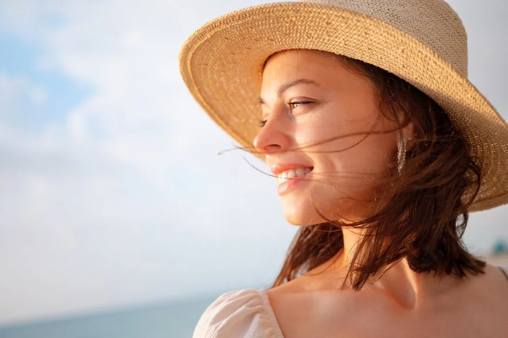 A happy tourist/expat enjoying their Bali holiday with a wide, confident smile after successful dental treatment.
