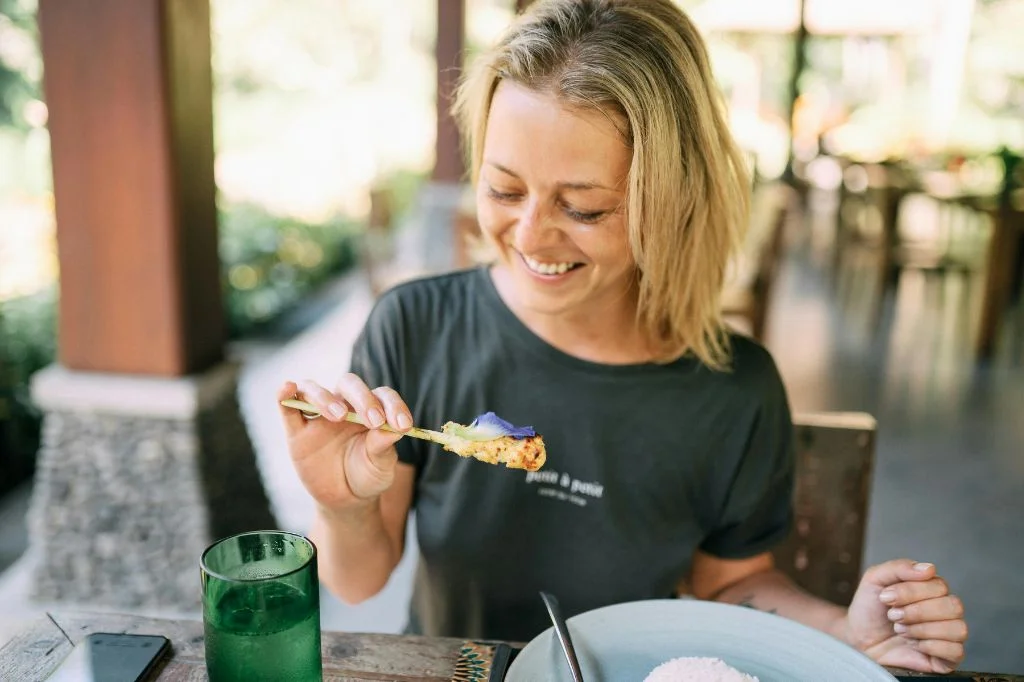 Traveler enjoying Bali food after dental restoration at Hydro Medical.