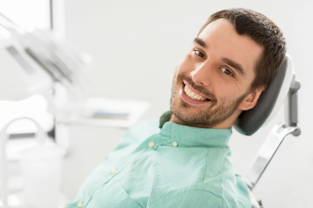 A patient smiling widely after having a treatment and consultation with local Bali dentist