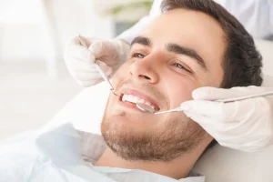 Examining a leaking dental restoration for hidden tooth decay.