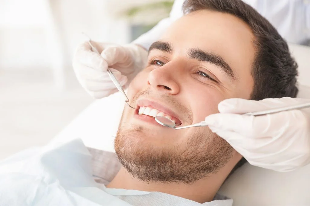 Examining a leaking dental restoration for hidden tooth decay.
