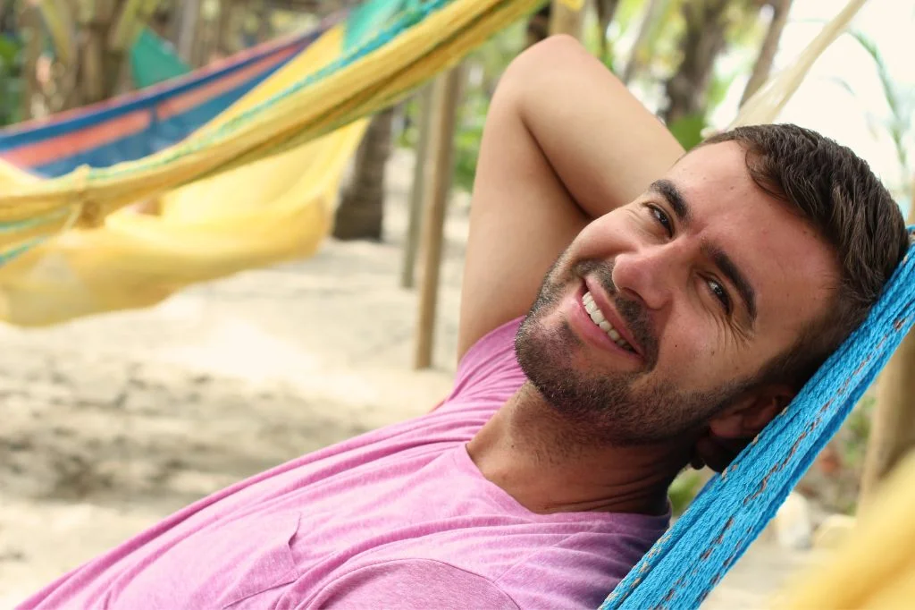 Traveler enjoying a tropical holiday with a confident, restored smile after dental treatment.