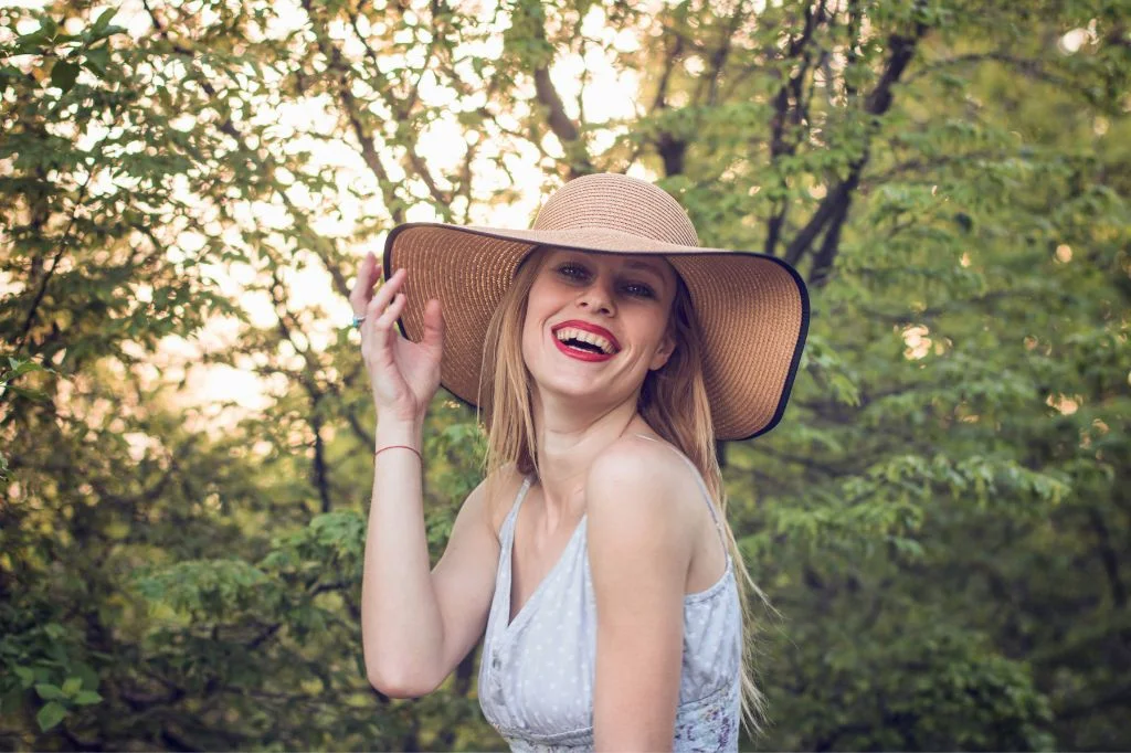 A traveler smiling widely in a tropical setting in Bali