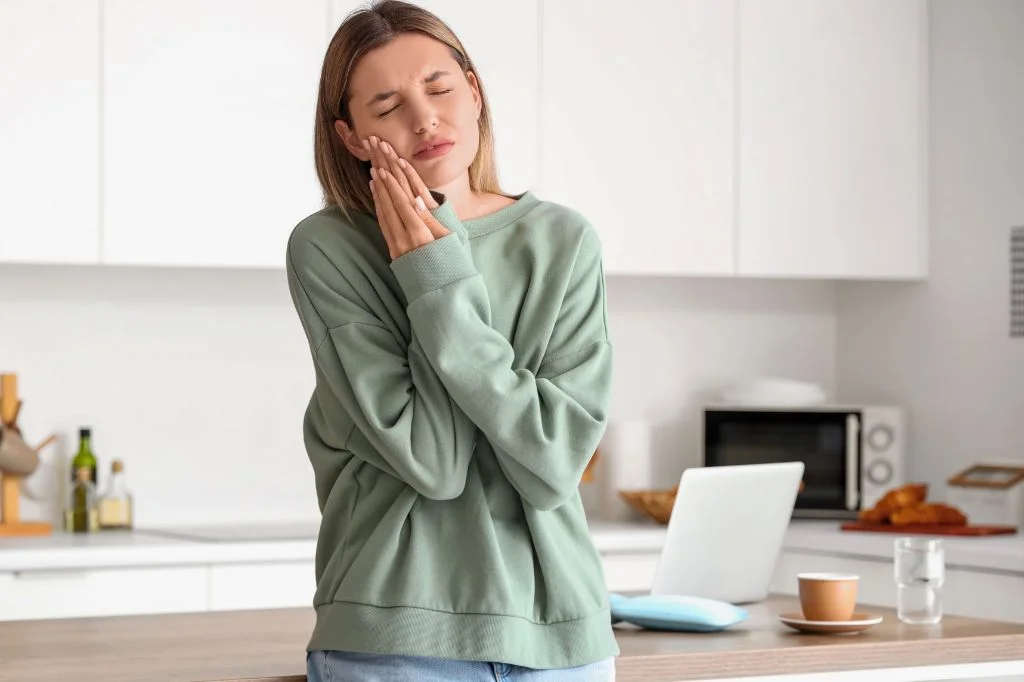A person experiencing wisdom tooth pain while working in Bali.