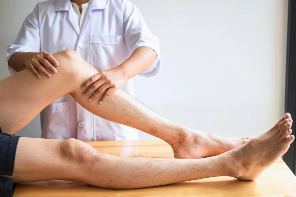 A professional physiotherapist treating severe muscle spasms through targeted manual release techniques in Bali.