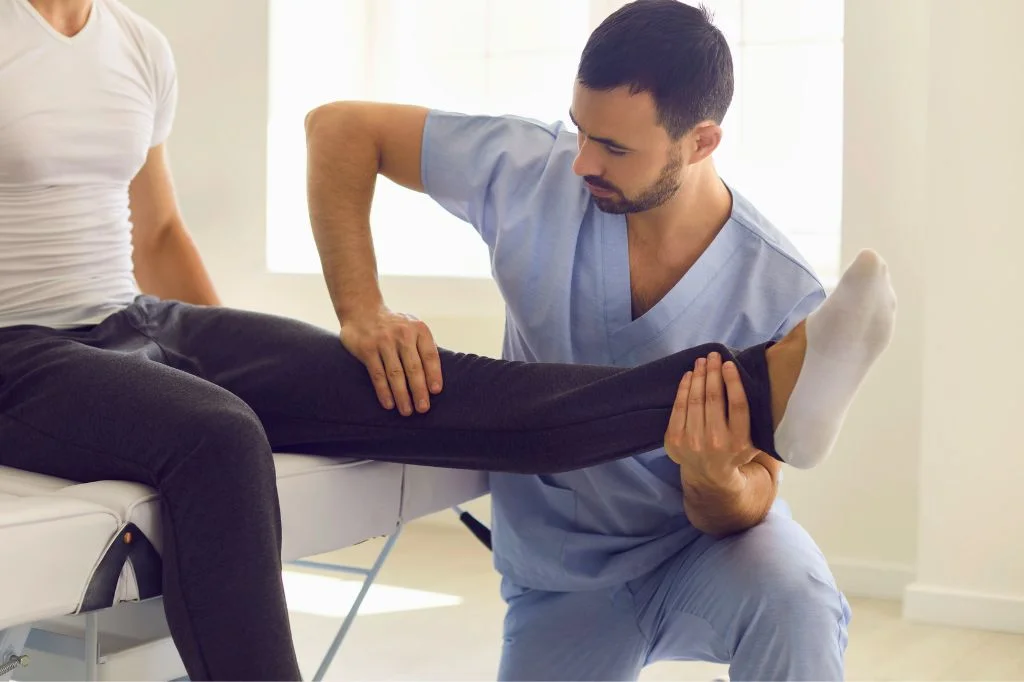 A professional physical therapist at Hydro Medical Clinic Bali providing a foot assessment for plantar fasciitis.