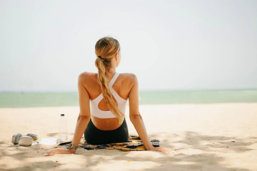 An active individual enjoying a peaceful holiday on a Bali beach, demonstrating successful recovery and freedom of movement.