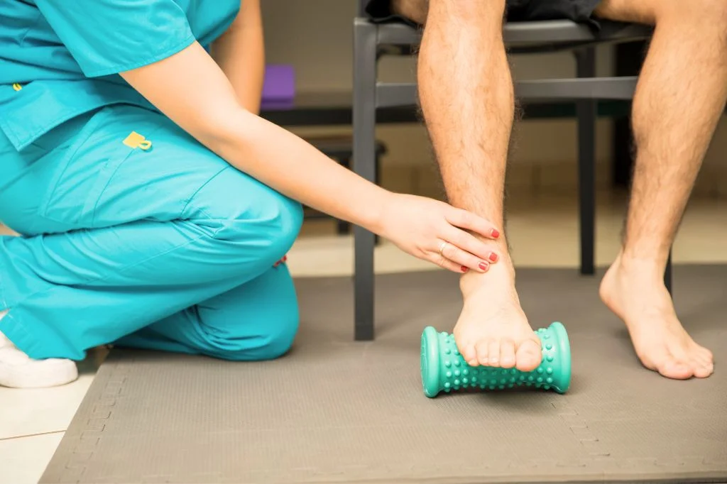 A professional physiotherapist at Hydro Medical Clinic Bali providing a foot assessment for plantar fasciitis.