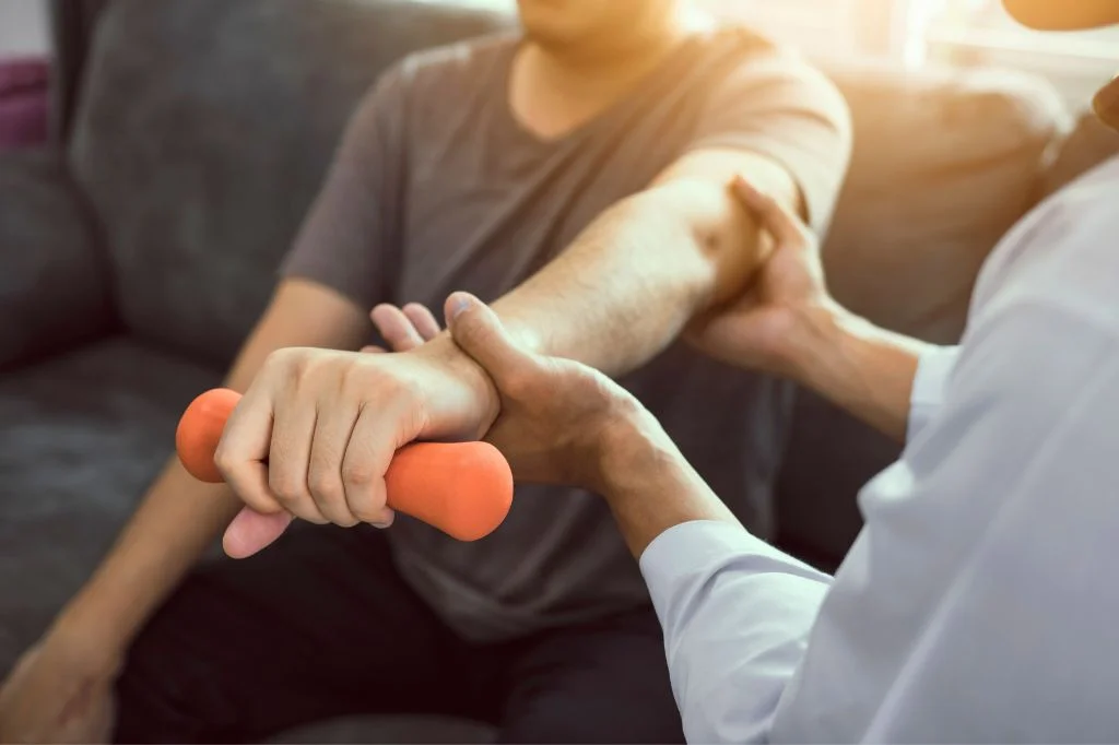 A licensed physiotherapist helping the patient to do a rehab.