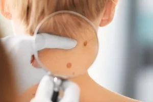 Traveler checking their shoulder and arm in natural clinic light